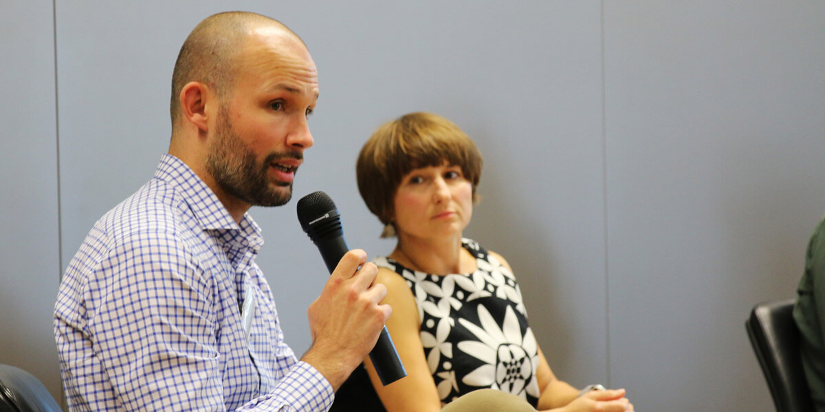 Jakub Eberle vom Institut für Internationale Beziehungen in Prag spricht in ein Mikrofon. Neben ihm sitzt Zuzana Lizcová von der Karsluniversität auf dem Podium im Hörsaal der Akademie für Politische Bildung.